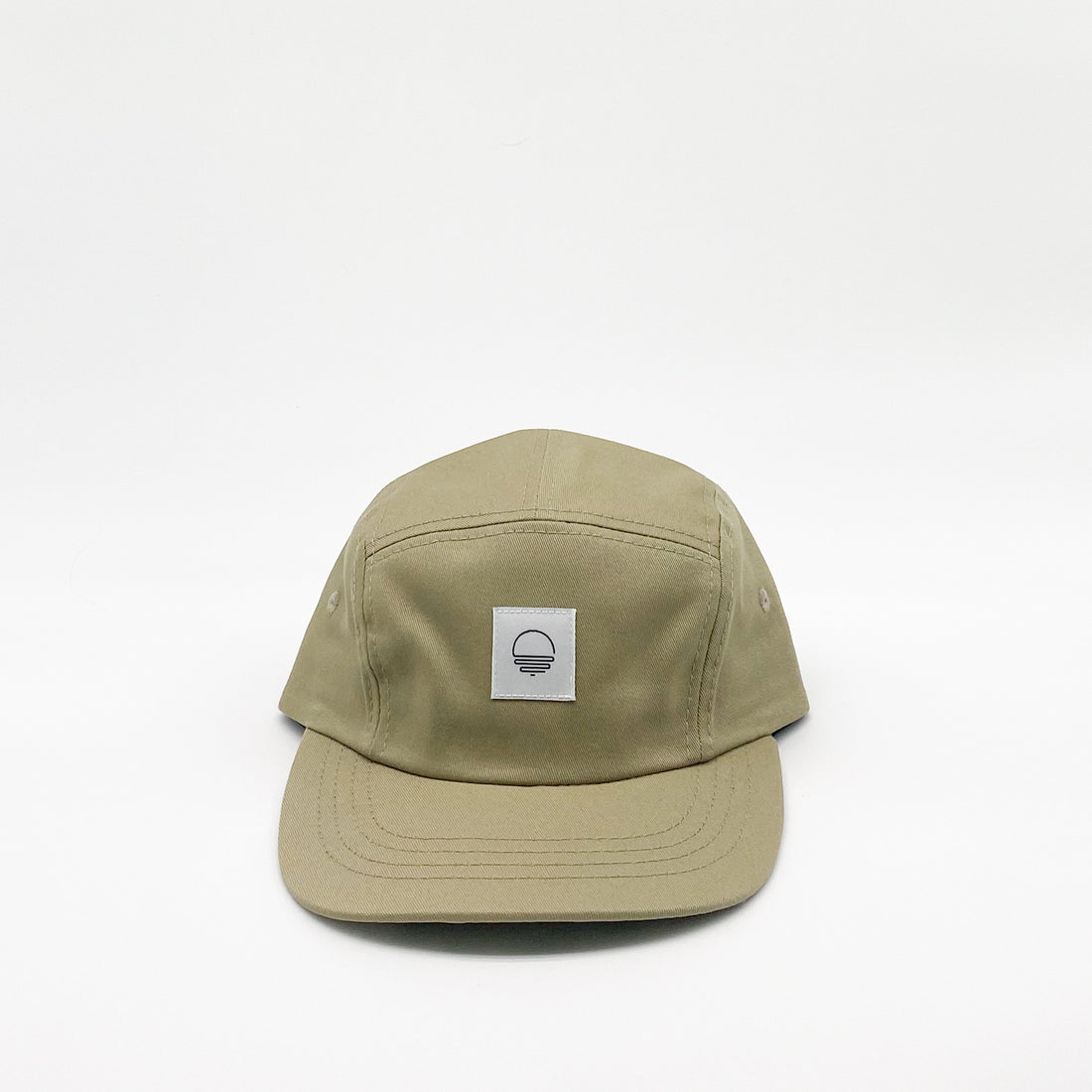 Khaki green kids hat. Minimalist five-panel design, made in Canada out of organic cotton. Hat has an adjustable soft velcro closure.