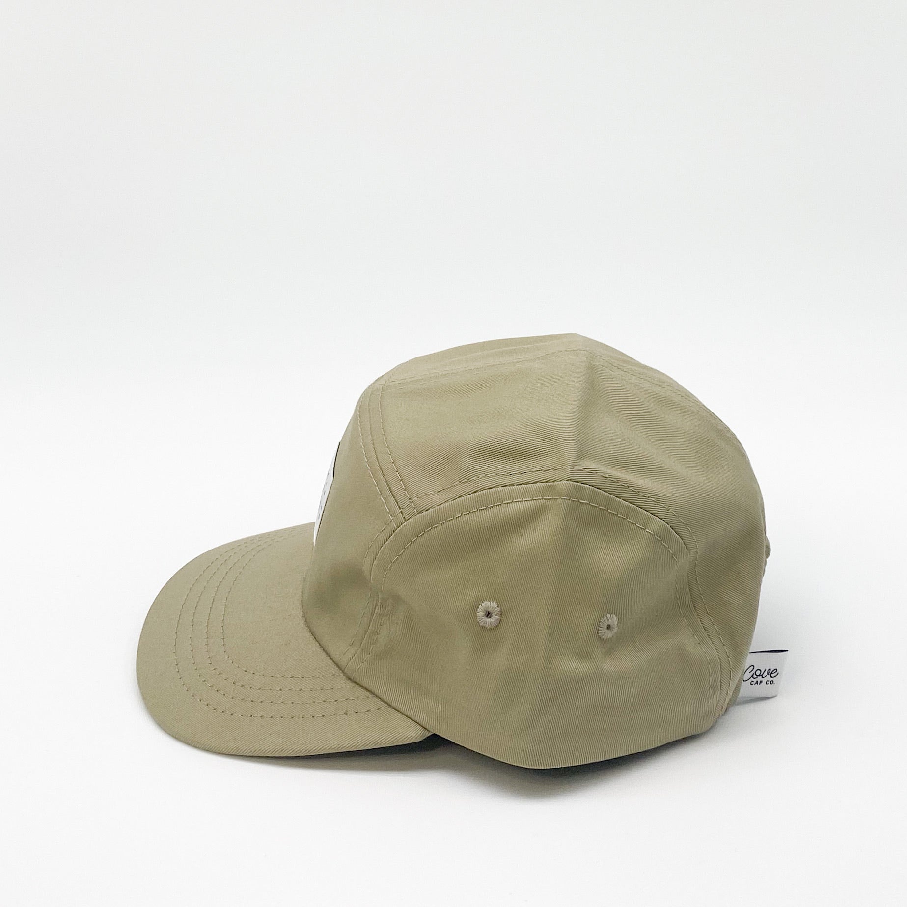 Khaki green kids hat. Minimalist five-panel design, made in Canada out of organic cotton. Hat has an adjustable soft velcro closure.