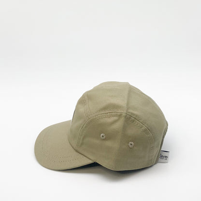 Khaki green toddler hat. Minimalist five-panel design, made in Canada out of organic cotton. Hat has an adjustable soft velcro closure and two eyelets on each side.